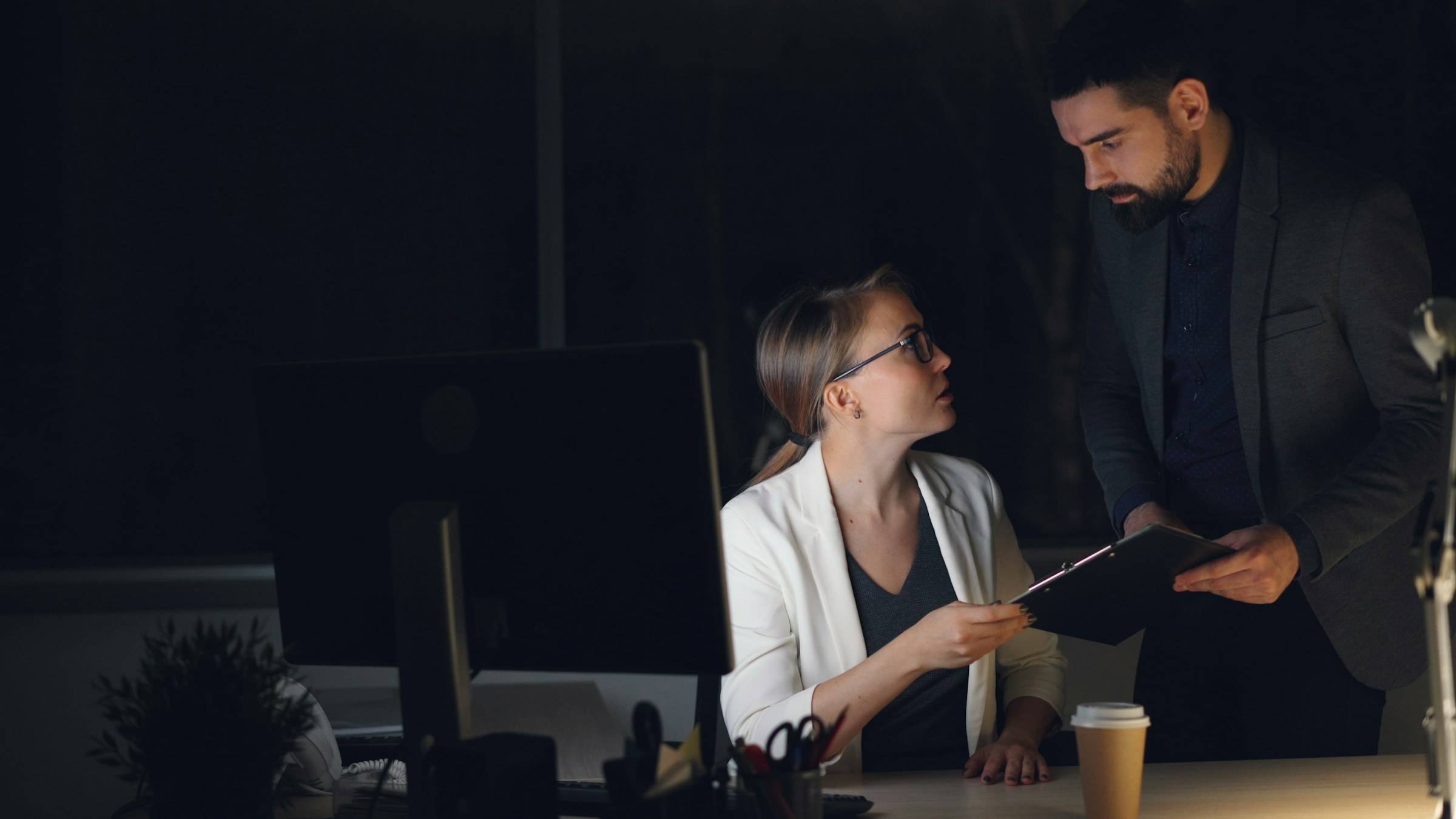 An experienced colleague guiding a founder through a plan late in the evening